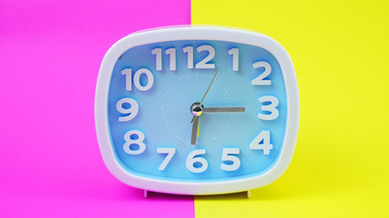 Blue Alarm clock on Yellows Pink background, Copy space for your text, Time concept. .