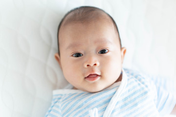 ベビーベッドに寝るかわいい赤ちゃん