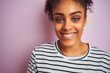 African american woman wearing navy striped t-shirt standing over isolated pink background with a happy face standing and smiling with a confident smile showing teeth