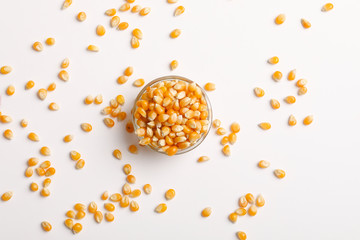 Dried corn seeds in bowl on white background 
