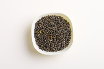 black gram seed or udad beans in bowl on white background 