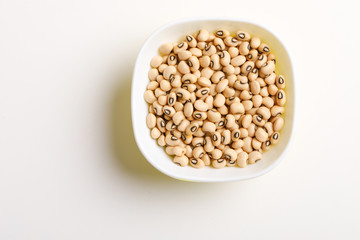 Black eyed seeds or chawali seeds in glass bowl on white background 