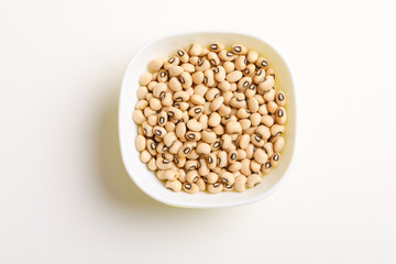 Black eyed seeds or chawali seeds in glass bowl on white background 