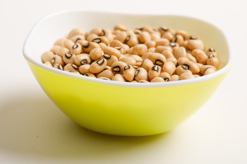 Black eyed seeds or chawali seeds in glass bowl on white background 