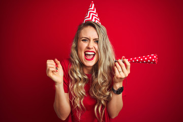 Young beautiful woman on birthday celebration over red isolated background screaming proud and celebrating victory and success very excited, cheering emotion