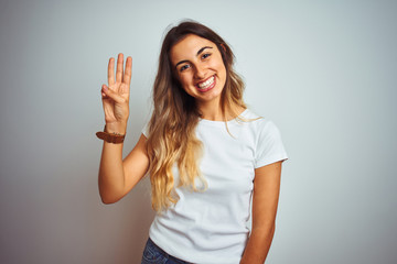 Fototapeta premium Young beautiful woman wearing casual white t-shirt over isolated background showing and pointing up with fingers number three while smiling confident and happy.