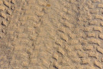 Tracks of the tires on a sand in desert