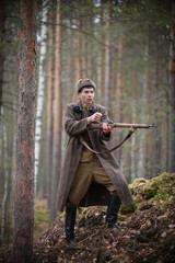 Fototapeta premium A soldier of World War II s reloading the rifle