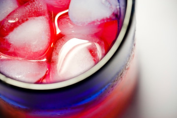 Top view of a glass of iced water - sweet red drink for refreshment in summer time