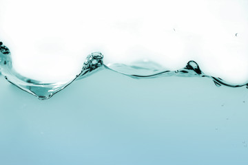 Water splash or water wave with bubbles of air on the background.