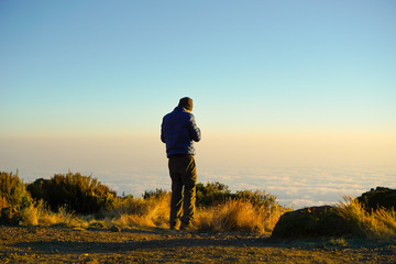 Guys sit and look forward.The stones are layers background Kilimanjaro Mountain in Tanzania