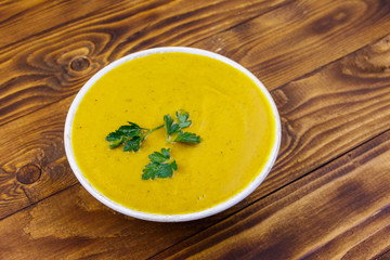 Pumpkin soup on a wooden table