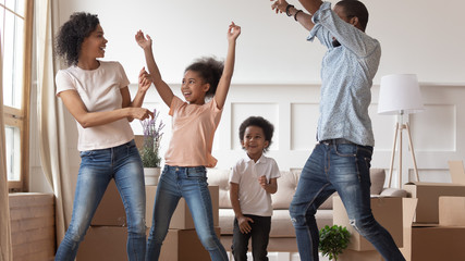 Smiling family with kids dance happy to move