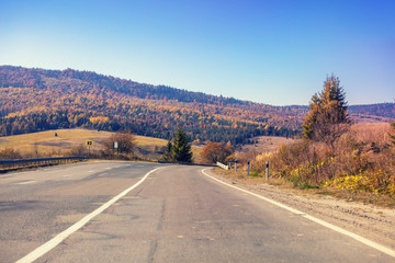 Driving a car on the mountain road. Empty road. View from a car of a mountain landscape in autumn