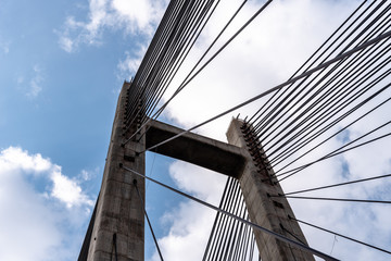 Modern suspension bridge. Detail of tower and steel cables. Barrios de Luna, Castile and Leon, Spain.