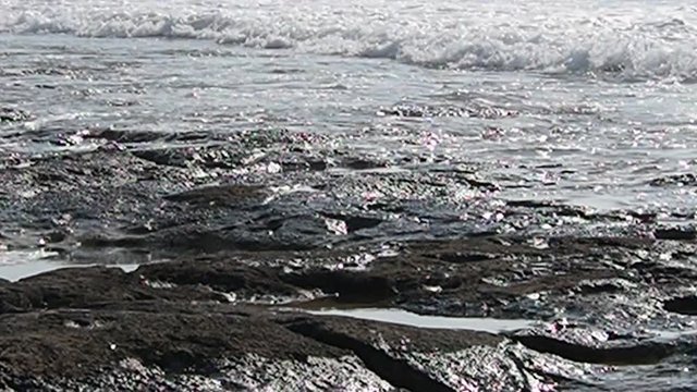Waves crashing on a beach in Cyprus. Rock, stone, sand in a sunny. Mediterranean sea. Paphos. 