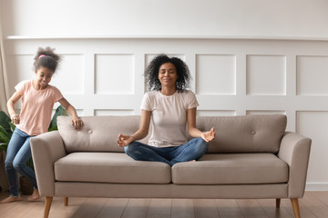 Obraz premium Calm black mom meditate distracted from outer noise