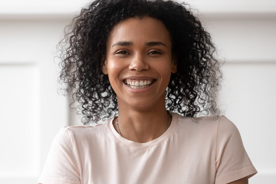 Headshot of smiling biracial girl posing for picture
