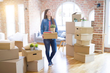 Beautiful asian young woman holding boxes, smiling happy moving to a new home