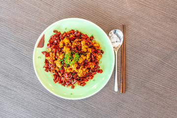 Sichuan Szechuan fried chicken with spicy red hot chillies. Asia China Chinese food cuisine. Chengdu Chongqing culinary.