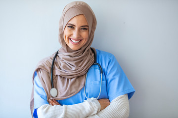Confident Muslim female doctor standing inside hospital. Portrait of Muslim Doctor with...