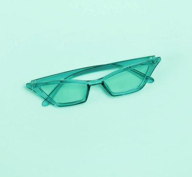 Stylish sunglasses isolated on the pastel green or mint background.