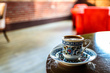 Small ornamental Traditional cup of turkish coffee on the table close up.