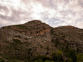Fototapeta na wymiar mountainous peak with caves and hiking trail