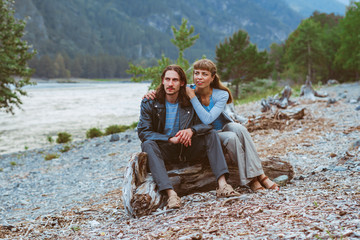 a couple of lovers sitting near the river