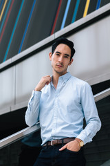 Portrait of young successful businessman in suit looking in front of camera