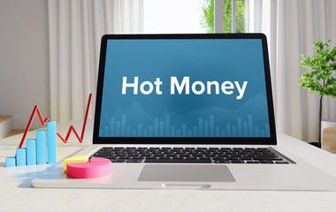 Hot Money – Statistics/Business. Laptop in the office with term on the display. Finance/Economics.