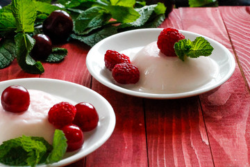 Panacota decorated with raspberries and mint
