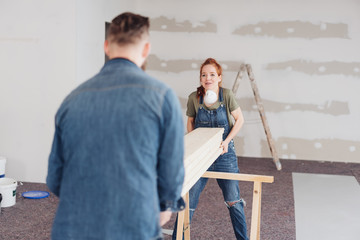 Naklejka premium Hardworking young couple doing DIY renovations