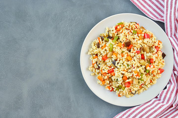 Bulgur pilaf with eggplant and vegetables. Top view  with copy space              
