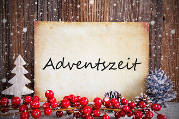 Fototapeta na wymiar Paper With German Text Adventszeit Means Advent Season. Christmas Decoration And Wooden Background With Snow