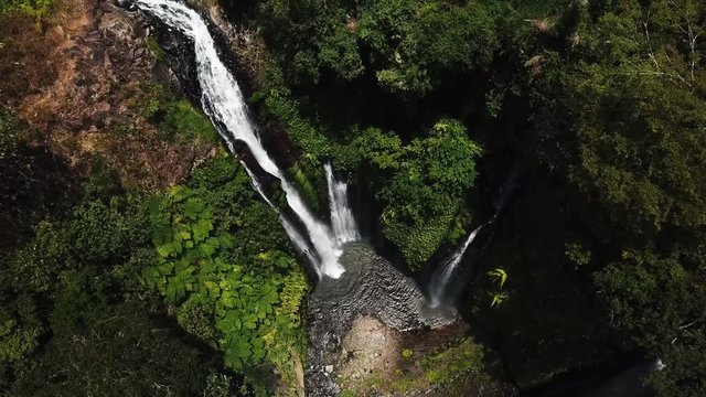 Aerial view on the Air Terjun Fiji waterfalls with the rainbow reflection in the middle of the rain forest, one of the most famous popular and beautiful destinations while travel to Bali, Indonesia.