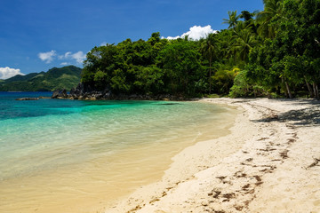 Turquoise and clear waters on the west side of the white sand Tuninon beach in Guijalo, municipality of Caramoan, Camarines Sur Province, Luzon, Philippines.