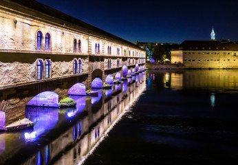 The Vauban Dam illuminated at night in Strasbourg, France, built in the 17th century on the river...
