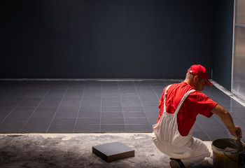 Floor ceramic tiles installation. Create, arranging.