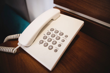 Details with an old school, retro/vintage style telephone on a nightstand