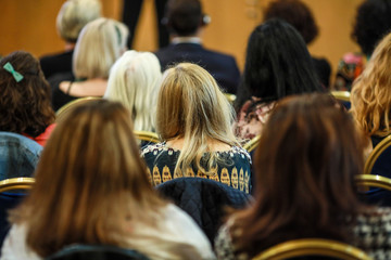 Women in the audience attending a conference - women targeted events.