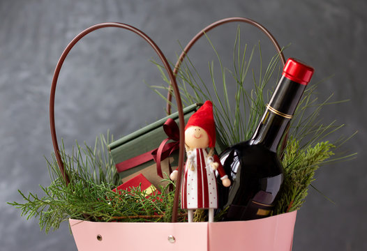 Christmas hamper with bottle of wine, gifts and festive goodies. Holiday gift