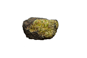 Olivine gemstone included in black lava basalt isolated on white background