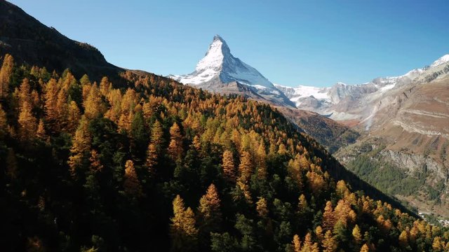 Matterhorn peak with golden larch at autumn. Zermatt, Switzerland.
