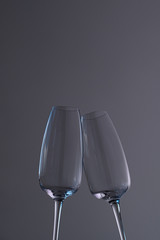 two empty champagne glasses on a dark background