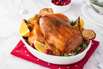 Christmas chicken in a white ceramic form on a light background. Christmas atmosphere.