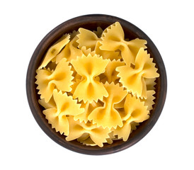 Raw farfalle pasta in bowl isolated on white background