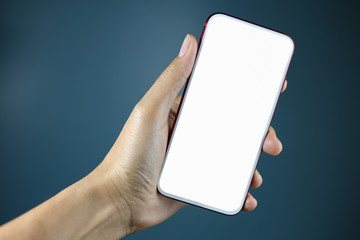Hand holding smartphone with white blank screen isolated.