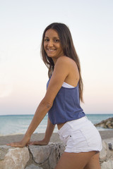 Slim young woman with positive attitude on the beach