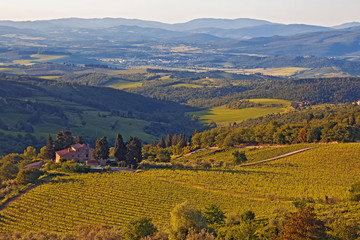 Tuscany landscape with rolling hills and valleys in sunset light